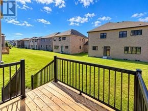 Oshawa (Kedron) apartment for rent - A balcony with a black railing overlooks a grassy area and a row of houses.