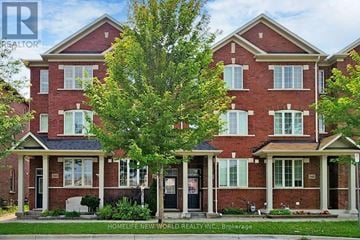 Markham (Cornell) townhouse for rent - A red brick house with a tree in front.