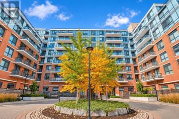 Richmond Hill (Jefferson) condo for rent - A tree with yellow leaves is in the middle of a courtyard surrounded by apartment buildings.