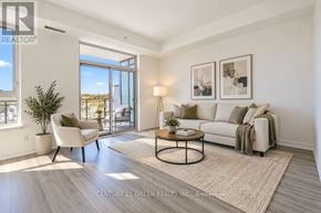 Richmond Hill (Jefferson) condo for rent - A well-lit living room with a white sofa, a coffee table, and a potted plant.