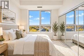 Richmond Hill (Jefferson) condo for rent - A bedroom with a large bed and a view of the city.