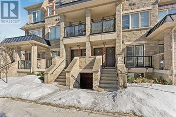 Brampton (Northwest Brampton) townhouse for rent - A large, multi-level home with a stone facade and a balcony overlooking the street.
