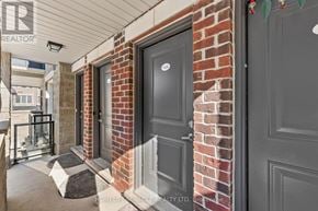 Brampton (Northwest Brampton) townhouse for rent - A brick wall with a black door and a grey door on the right.