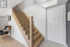 Brampton (Northwest Brampton) townhouse for rent - A staircase with a wooden banister and a white door.