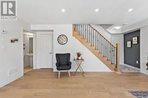 Brampton (Northwest Brampton) townhouse for rent - A living room with a wooden floor and a staircase.