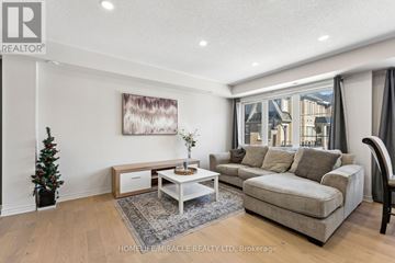 Brampton (Northwest Brampton) townhouse for rent - A living room with a couch, coffee table, and a painting on the wall.