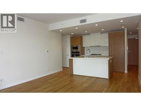 West Vancouver apartment for rent - A realtor logo is on the wall of a kitchen.
