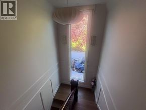 West Vancouver apartment for rent - A hallway with a car parked outside the window.