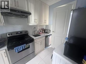 West Vancouver apartment for rent - A kitchen with white cabinets and a black stove top.