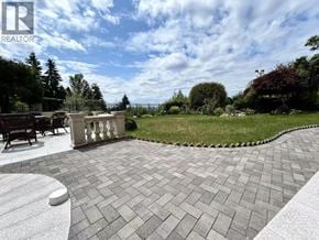 West Vancouver apartment for rent - A patio with a brick patterned floor and a white circular object on it.
