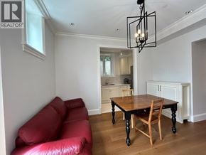 West Vancouver apartment for rent - A living room with a red couch and a wooden table.