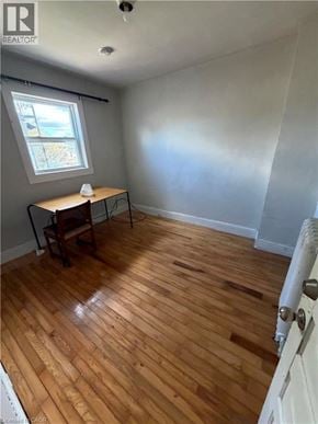 Brantford apartment for rent - A room with wooden flooring and a window.