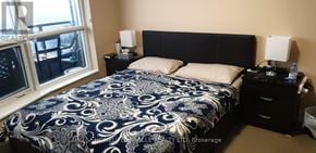 Toronto (Agincourt South-Malvern West) condo for rent - A bedroom with a bed, nightstands, and a window.