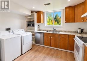 Guelph (Kortright Hills) apartment for rent - A kitchen with white appliances and wooden cabinets.