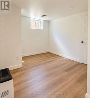 Guelph (Kortright Hills) apartment for rent - A room with wooden flooring and white walls.