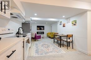 Stratford apartment for rent - A kitchen with a white oven and a dining table with chairs.