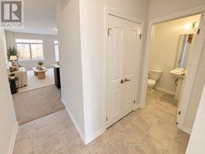 Haldimand townhouse for rent - A white door is in a hallway with a bathroom visible in the background.