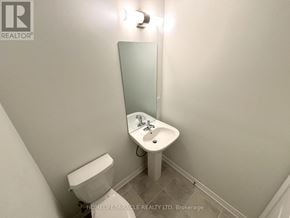 Haldimand townhouse for rent - A white toilet and sink in a small bathroom.