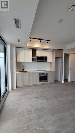 Toronto (Islington-City Centre West) condo for rent - A modern kitchen with a large island and a refrigerator.