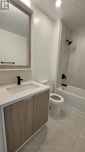 Toronto (Islington-City Centre West) condo for rent - A white bathroom with a sink, toilet and bathtub.