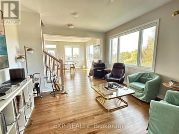Ottawa townhouse for rent - A living room with a green chair and a coffee table.