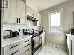 Ottawa townhouse for rent - A kitchen with white cabinets and a black stove top.