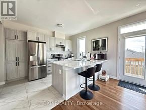 Ottawa townhouse for rent - A kitchen with a refrigerator, stove, and sink.