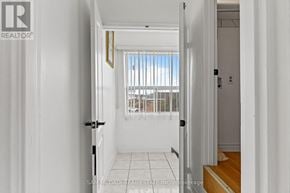 Toronto (Humber Summit) apartment for rent - A hallway with a door on the left and a window with blinds on the right.