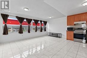 Toronto (Humber Summit) apartment for rent - A large, empty room with a kitchen area to the right.