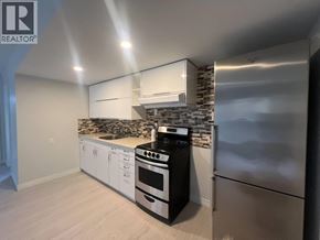 Maple Ridge apartment for rent - A modern kitchen with stainless steel appliances and white cabinets.