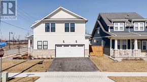 Fort Erie (Crystal Beach) apartment for rent - A white house with a garage is in front of a blue house.