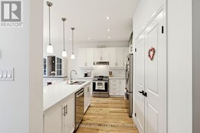 Fort Erie (Crystal Beach) apartment for rent - A modern kitchen with white cabinets and a wooden floor.