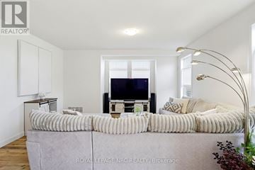 Fort Erie (Crystal Beach) apartment for rent - A living room with a grey couch and a television.