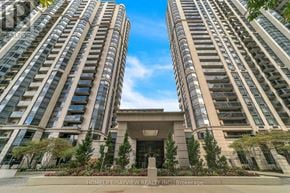 Toronto (Lansing-Westgate) condo for rent - A tall building with a glass facade and a stone entrance.