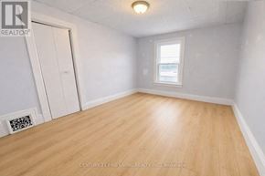 Barrie (City Centre) apartment for rent - A room with wooden flooring and a window.