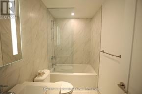 Toronto (Waterfront Communities) condo for rent - A white bathroom with a glass shower door and a white toilet.