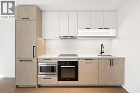 Toronto condo for rent - A modern kitchen with wooden cabinets and stainless steel appliances.