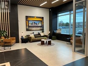St John's house for rent - A modern living room with a large window overlooking a parking lot.