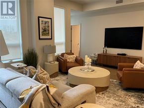 St John's house for rent - A living room with a large flat screen TV mounted on the wall.