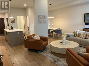 St John's house for rent - A living room with a brown couch and a white coffee table.
