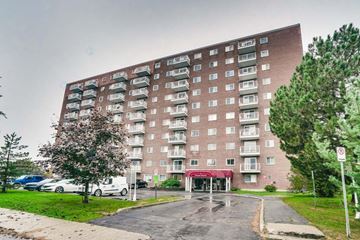 Gatineau (Hull) condo for rent - A tall apartment building with a red awning at the entrance.