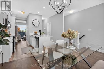 London South (South U) townhouse for rent - A modern kitchen with a glass table and white chairs.