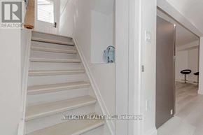 Halton Hills (Georgetown) apartment for rent - A staircase in a house with a logo of Intercity Realty INC. Brokerage on the wall.
