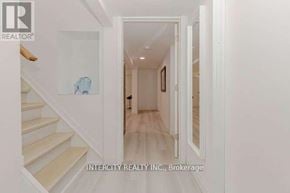 Halton Hills (Georgetown) apartment for rent - A hallway with white walls and a wooden floor.