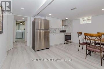 Halton Hills (Georgetown) apartment for rent - A kitchen with a stainless steel refrigerator and a dining table with chairs.
