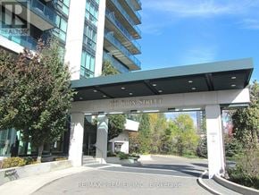 Brampton (Downtown Brampton) condo for rent - The entrance to a building with a sign that reads "100 John Street".