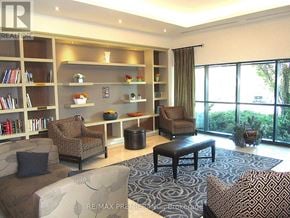 Brampton (Downtown Brampton) condo for rent - A living room with a couch, chair, and coffee table.
