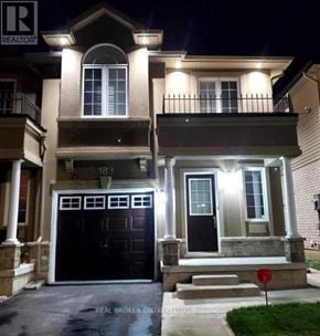 Hamilton (Stoney Creek) townhouse for rent - A house with a black front door and a red stop sign in front.