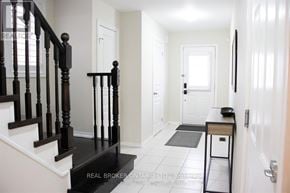 Hamilton (Stoney Creek) townhouse for rent - A hallway with a black staircase and white walls.