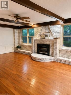 Hamilton apartment for rent - A living room with a fireplace and a ceiling fan.